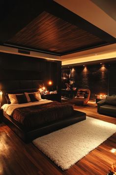 a large bed sitting on top of a wooden floor next to a chair and lamp