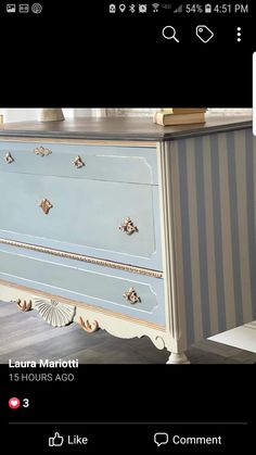 an old dresser is painted blue and has gold trimmings on the bottom half