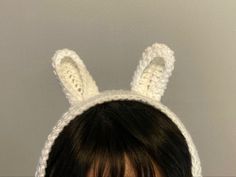 a woman wearing a crocheted bunny ears hat