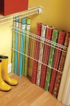 a pair of yellow rain boots sitting on top of a wooden floor next to books