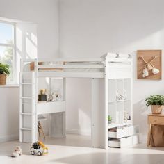 there is a white loft bed with a desk and ladder in the room next to it