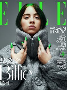 a woman with green nails on the cover of a magazine, wearing a grey coat