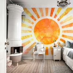 an orange and yellow sun painted on the wall in a bedroom with a white chair