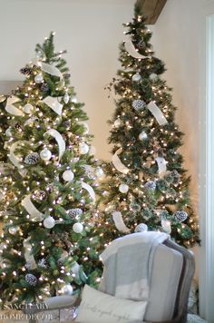 two christmas trees decorated with white and silver ornaments