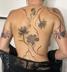 the back of a woman with tattoos on her body