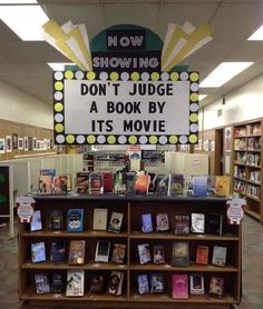 there is a sign that says now showing don't judge a book by its movie