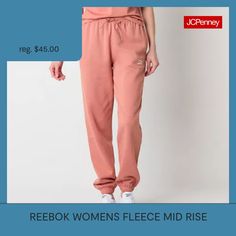 You'll love the vibrant pink hue and sporty aesthetic of these Reebok women's mid-rise fleece jogger pants for lounging or workouts. Crafted from 100% cotton, these cuffed-leg joggers come lined with an embroidered logo, slip pockets, and an elastic-drawstring waist. Wear them with a tee to complete the look. Front Style: Flat FrontClosure Type: Drawstring, Full ElasticFit: Regular FitPockets: 2 Side Slip PocketsRise: Mid RiseFiber Content: 100% CottonFabric Description: FleeceLining: LinedLini… Sporty Pink Fleece Joggers, Pink Fleece Sportswear Bottoms, Sporty Pink Fleece Bottoms, Casual Pink Fleece Joggers, Trendy Pink Sweatpants For Sports, Spring Fleece Joggers For Jogging, Pink Athleisure Joggers For Winter, Winter Athleisure Pink Joggers, Pink Winter Athleisure Joggers