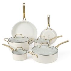 a set of white and gold pots and pans