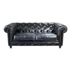 a black leather couch sitting on top of a white floor