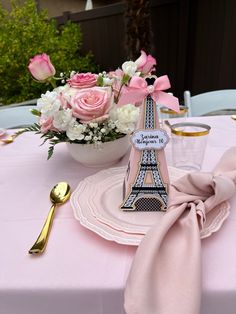 the table is set with pink napkins and place settings for two people to eat