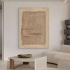 a living room with white furniture and a large painting on the wall above the coffee table