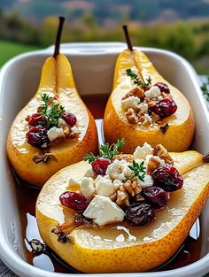 three pears with cheese and cranberries in a dish