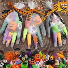 several halloween hand decorations are arranged on a table