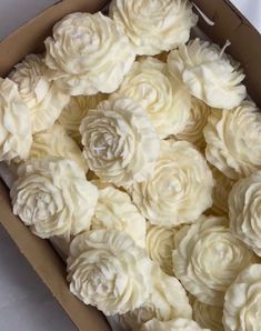 a box filled with white flowers sitting on top of a table