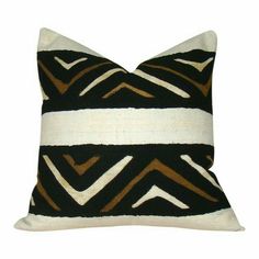 a black and white pillow with gold stripes