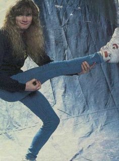 an old photo of a woman posing on a skateboard in front of a backdrop