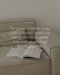 an open book sitting on top of a couch next to a wall with a quote about the power of mindful design crafts authentic brands that amplify your story, expand