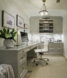 a home office with gray cabinets and white furniture