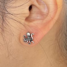 Embrace these Ocean theme octopus stud earrings in titanium. These unique earrings feature intricately detailed, adding a touch of edgy sophistication to any outfit. Perfect for those who love sea creature earrings. ▪️▪️▪️PRODUCT Sold by Pair = 2pcs Earring Post 0.8mm=20g Material: Titanium VISIT STORE FOR MORE PRODUCT 🔗 https://www.etsy.com/ca/shop/TWISTEEL ▪️▪️▪️ S H I P P I N G   All orders will be shipped on the next business day UNITED STATES  - USPS First-Class Mail * 4 - 14 Business Days  Tracking & Insurance included CANADA - Canada Post * 4 - 14 Business Days Tracking & Insurance included EUROPE * 6 - 14 Business Days Tracking & Insurance included AUSTRALIA & ASIA  * 6 - 21 Business Days Tracking & Insurance included ▪️▪️▪️ S A T I S F A C T I O N * G U A R A N T E E Accidents ha Tentical Earrings, Octopus Earrings, Ocean Earrings, Ocean Jewelry, Titanium Jewelry, Nose Rings Hoop, Earring Post, Ocean Theme, Sea Creature