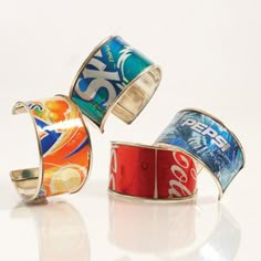 three rings with coca - cola designs on them, one is red and the other is blue