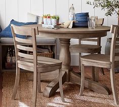 a dining room table with four chairs around it