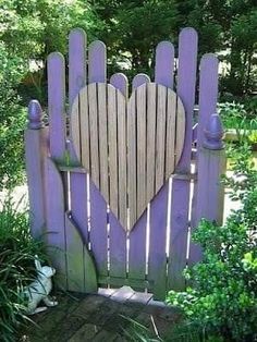 a wooden fence with a heart shaped gate