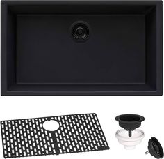 a black sink and accessories for a kitchen