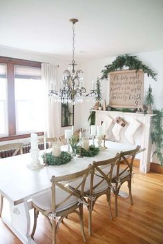 a dining room table with christmas decorations on the top and candles in front of it