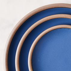 three blue plates stacked on top of each other