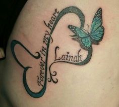 a woman's stomach with a butterfly and the word love written in cursive writing