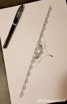 a pen sitting on top of a piece of paper next to an ink drawing pattern