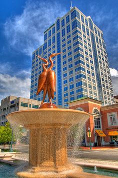 a fountain in front of a tall building