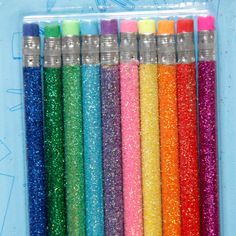 six different colored glitter pencils in a package