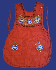 an old red apron with blue flowers on it