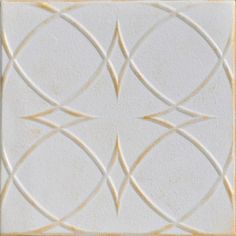 a white tile with gold lines on the center and bottom, as well as an intricate design