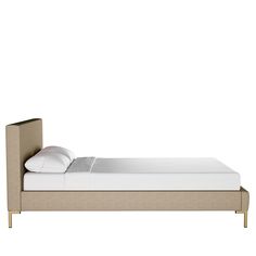 the bed is made up with white sheets and beige headboard, along with two pillows