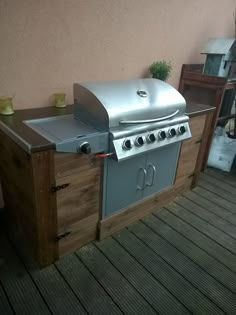 an outdoor bbq grill on a wooden deck