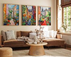 a living room with three paintings on the wall