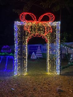 a lighted archway decorated with lights and bows