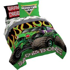 a bed with monster trucks and flames on it