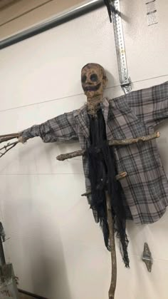 an old scarecrow hanging on the wall