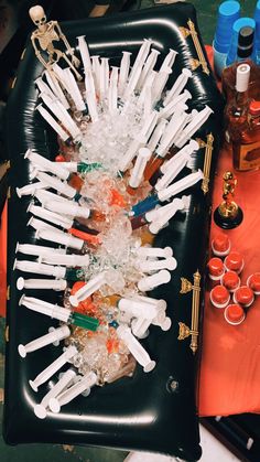 an inflatable tray filled with lots of plastic bottles and cups on top of a table