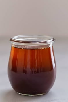 a glass jar filled with liquid sitting on top of a table