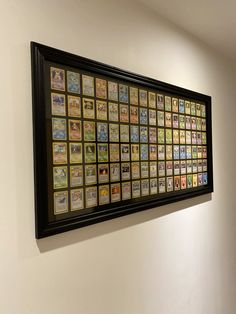 a wall with pictures on it in a room