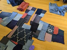 many pairs of jeans are laid out on the floor