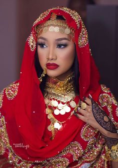 a woman dressed in red and gold