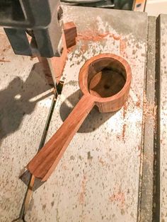 a piece of wood is being worked on with a drill bit in the shape of a spoon