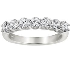 a white gold wedding band with five round cut diamonds on the top and bottom half