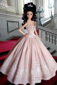 a barbie doll wearing a pink dress and tiara standing on some red carpeted stairs