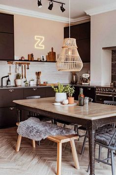 a wooden table sitting in the middle of a kitchen next to a stove top oven